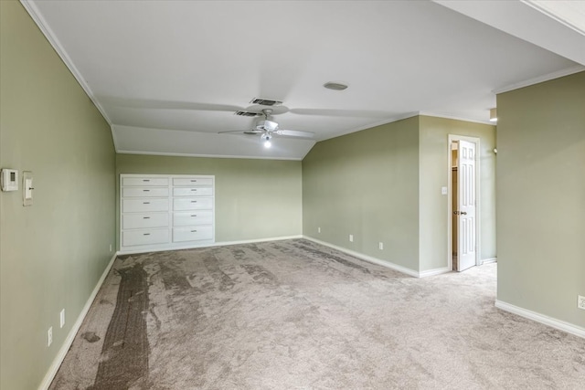 unfurnished bedroom with crown molding, light carpet, lofted ceiling, and ceiling fan