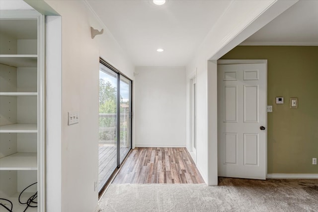 interior space featuring ornamental molding and light hardwood / wood-style floors