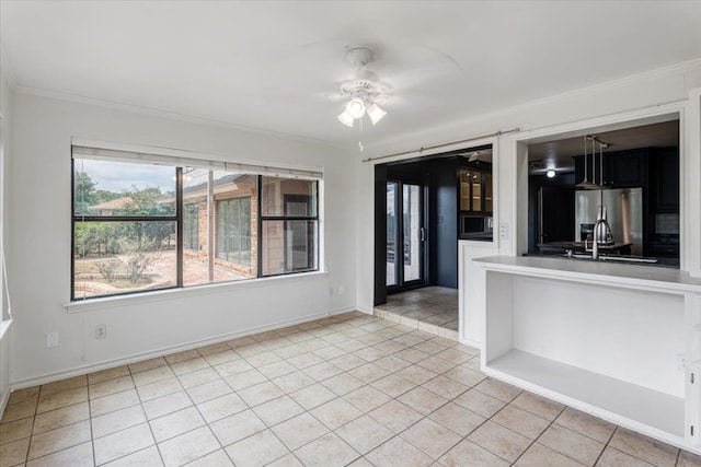 unfurnished room featuring sink, ceiling fan, crown molding, and light tile patterned flooring