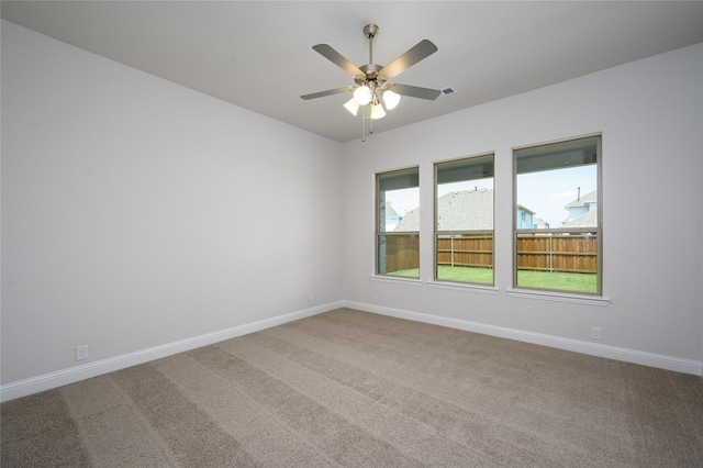 unfurnished room with carpet flooring and ceiling fan