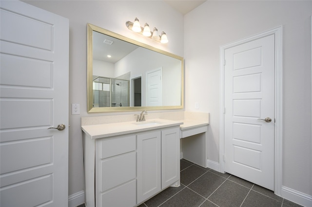 bathroom featuring tile patterned floors, vanity, and walk in shower