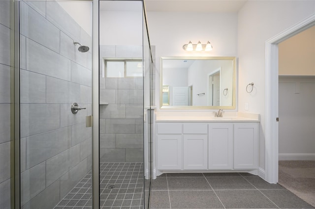 bathroom featuring tile patterned flooring, vanity, and an enclosed shower