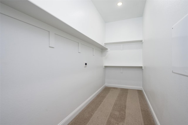 spacious closet with carpet floors