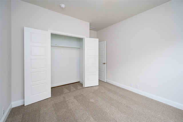 unfurnished bedroom with carpet and a closet