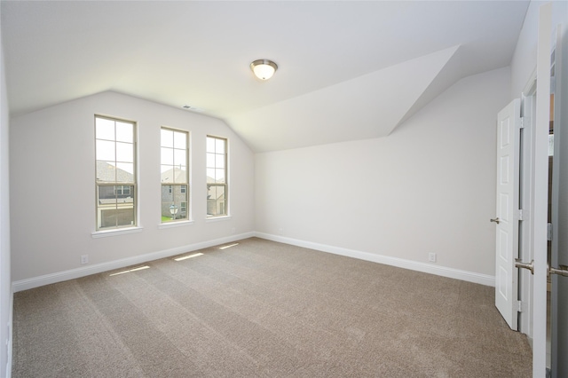 bonus room featuring carpet flooring and lofted ceiling