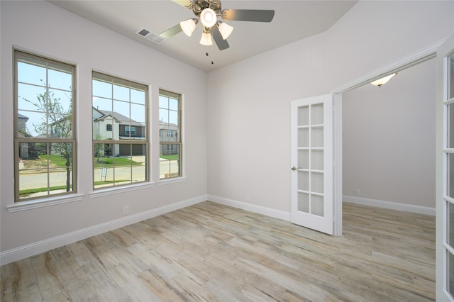 unfurnished room featuring french doors, light hardwood / wood-style flooring, and ceiling fan