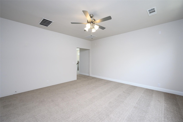 empty room featuring ceiling fan and light colored carpet