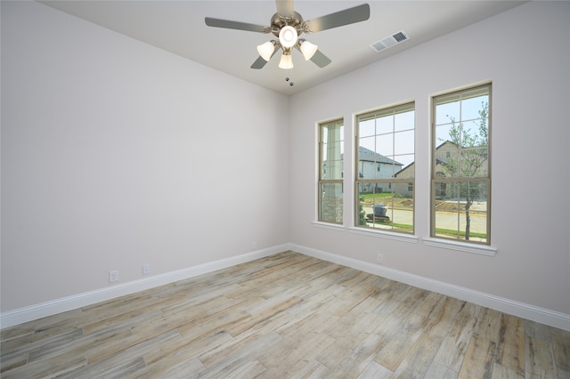 empty room featuring ceiling fan and light hardwood / wood-style flooring