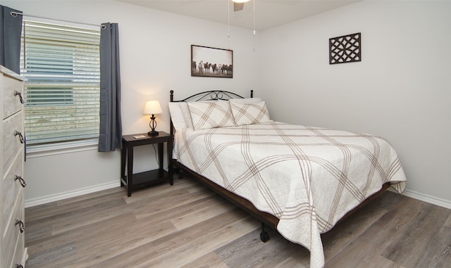 bedroom with hardwood / wood-style flooring and ceiling fan