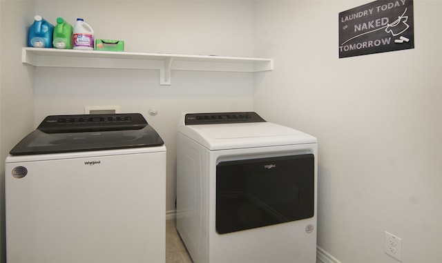 clothes washing area with washer and clothes dryer