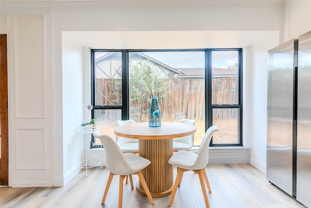 dining space with a wealth of natural light and light hardwood / wood-style floors