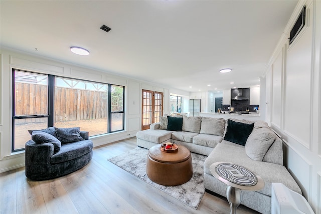 living room featuring light hardwood / wood-style flooring and french doors