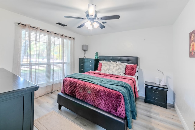 bedroom with light wood-type flooring and ceiling fan