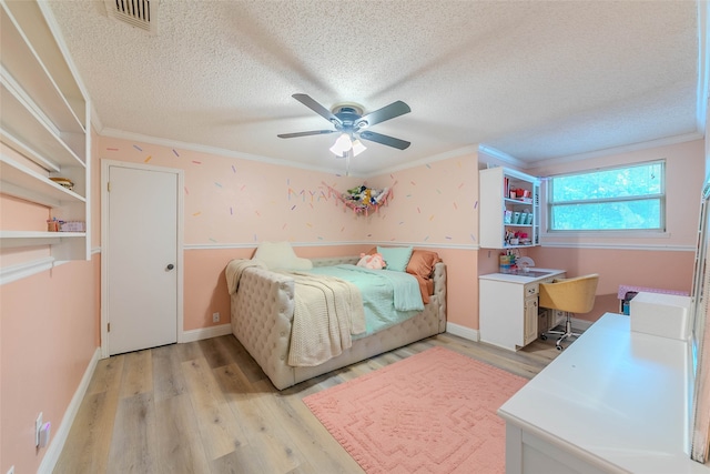 bedroom featuring ceiling fan, crown molding, a textured ceiling, and light hardwood / wood-style flooring