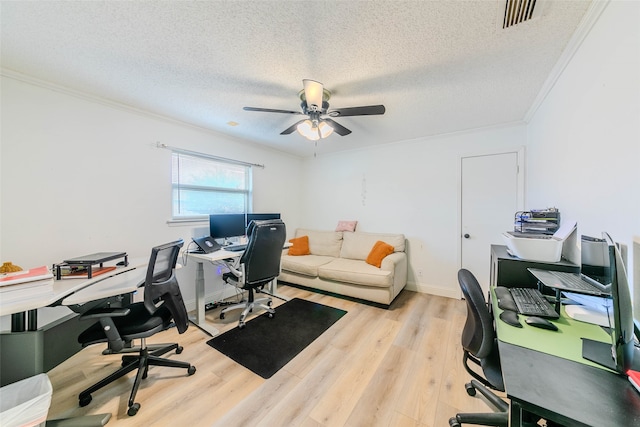 office area featuring crown molding, a textured ceiling, light wood-type flooring, and ceiling fan