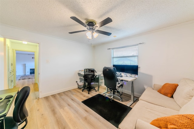 office featuring ceiling fan, a textured ceiling, light hardwood / wood-style flooring, and ornamental molding