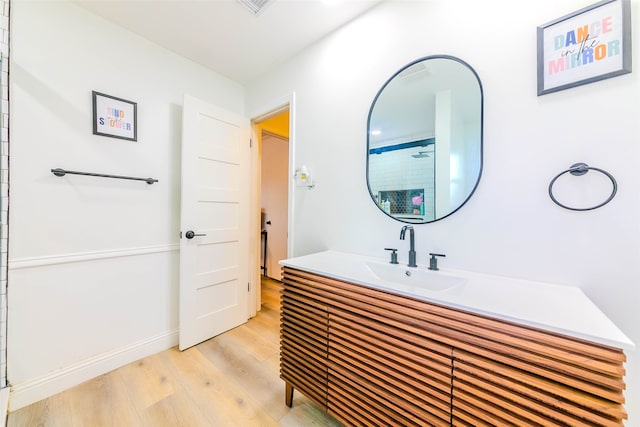 bathroom with vanity, hardwood / wood-style floors, and walk in shower