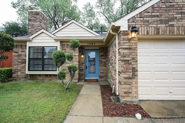 view of exterior entry with a lawn