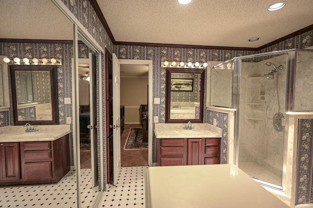 bathroom with vanity, a textured ceiling, an enclosed shower, and crown molding