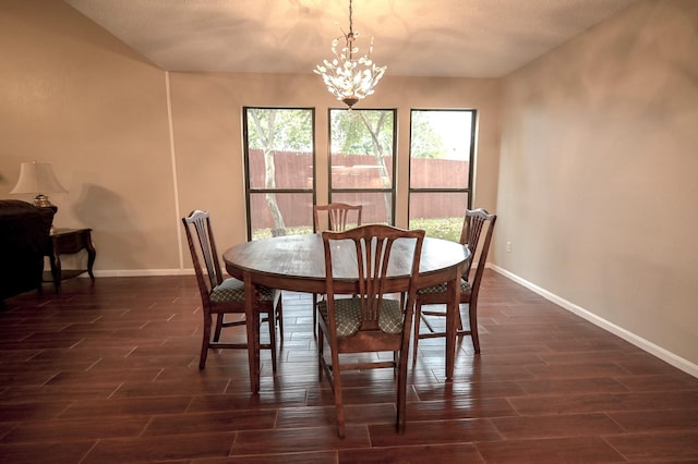 dining room with dark wood-type flooring, a chandelier, and a textured ceiling