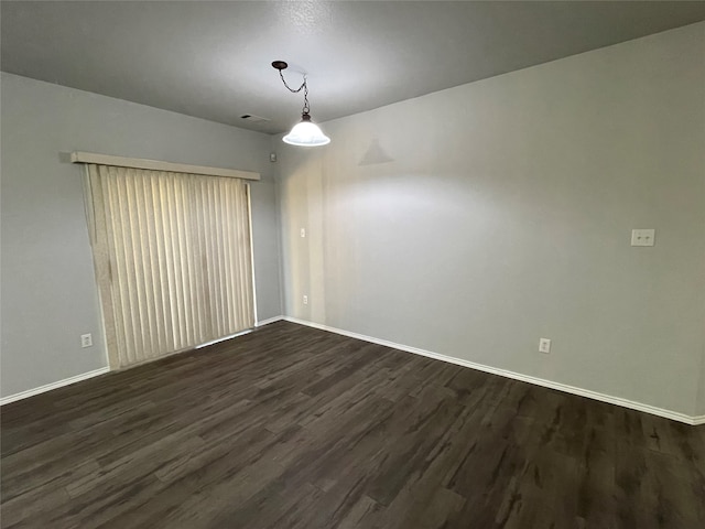 unfurnished room featuring dark wood-type flooring