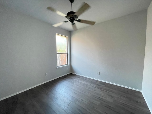 spare room featuring dark wood-type flooring and ceiling fan