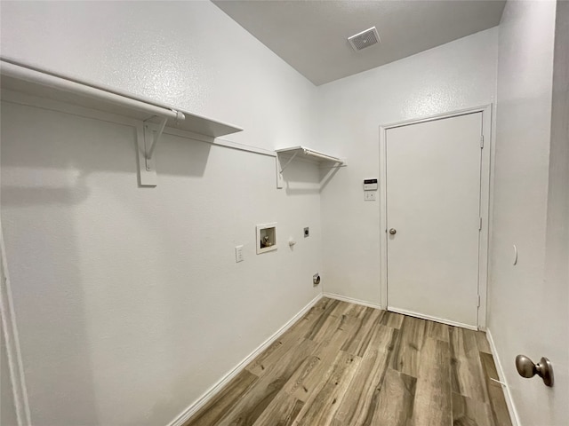 laundry room with light hardwood / wood-style flooring, electric dryer hookup, and hookup for a washing machine