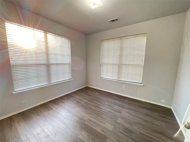 empty room with dark hardwood / wood-style floors