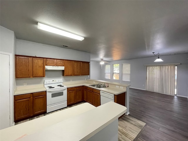 kitchen with white appliances, kitchen peninsula, hardwood / wood-style floors, hanging light fixtures, and ceiling fan