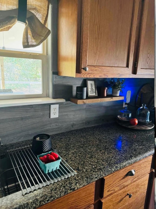 kitchen with tasteful backsplash and dark stone counters