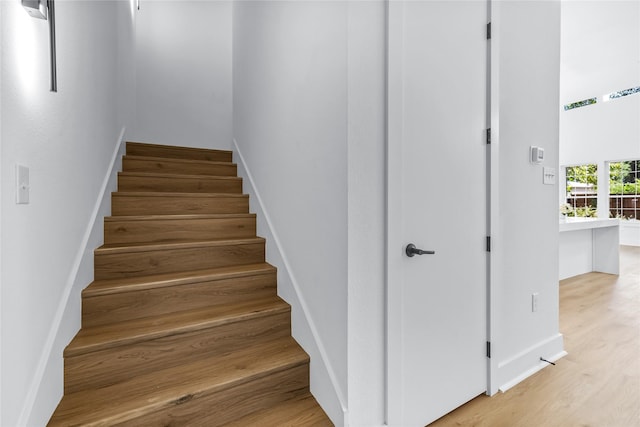 staircase featuring hardwood / wood-style floors