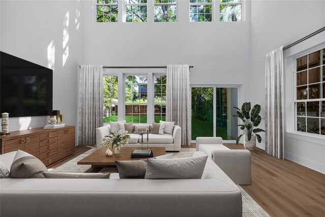 2320 Arroyo Ave, Dallas, TX 75219 - living room with a high ceiling, wood finished floors, and healthy amount of natural light