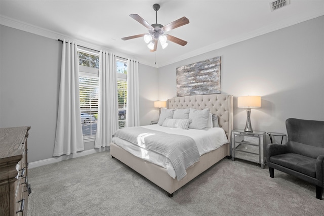 carpeted bedroom with ceiling fan and crown molding