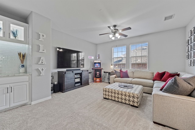 living room with light colored carpet and ceiling fan