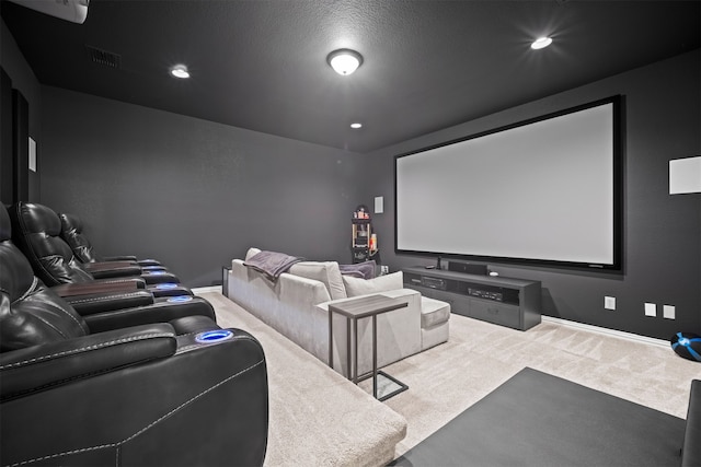 carpeted home theater with a textured ceiling