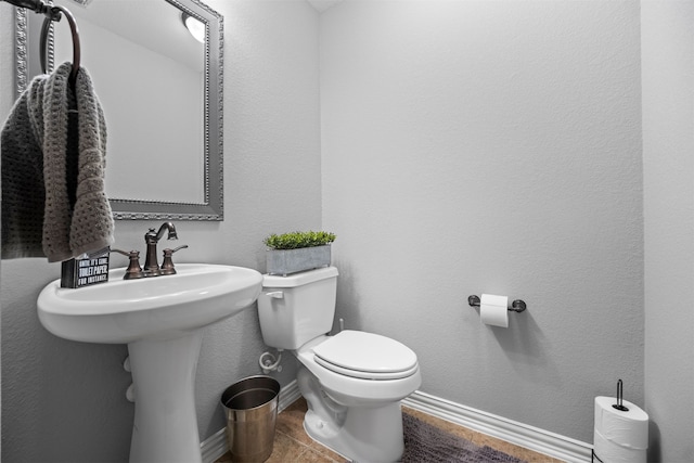 bathroom with toilet and tile patterned flooring