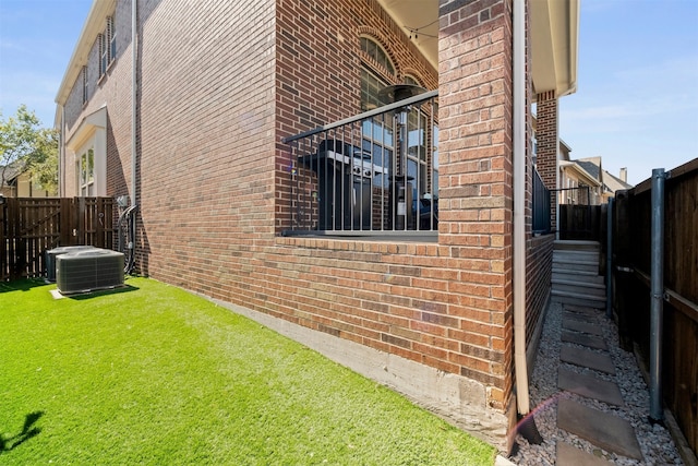 view of home's exterior with a yard and cooling unit