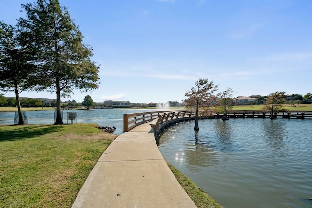 dock area featuring a water view and a lawn