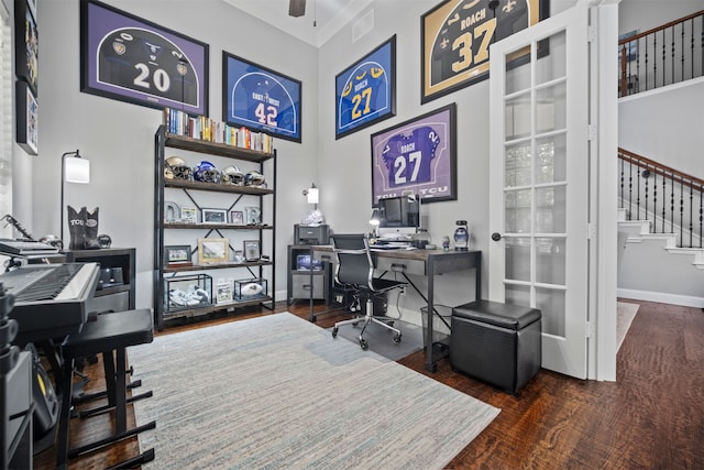 office space with dark wood-type flooring, ceiling fan, and crown molding