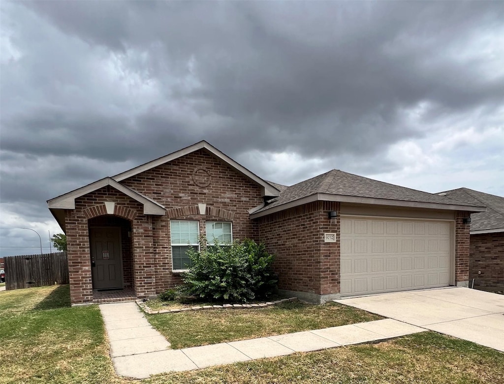 view of front facade featuring a garage and a front lawn