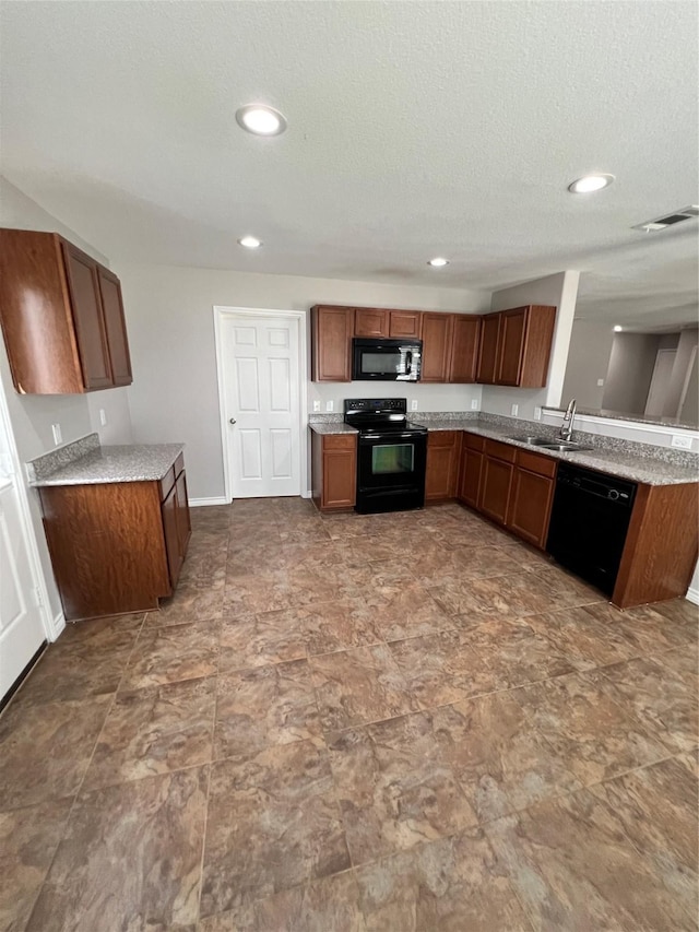 kitchen featuring black appliances, kitchen peninsula, sink, and a textured ceiling