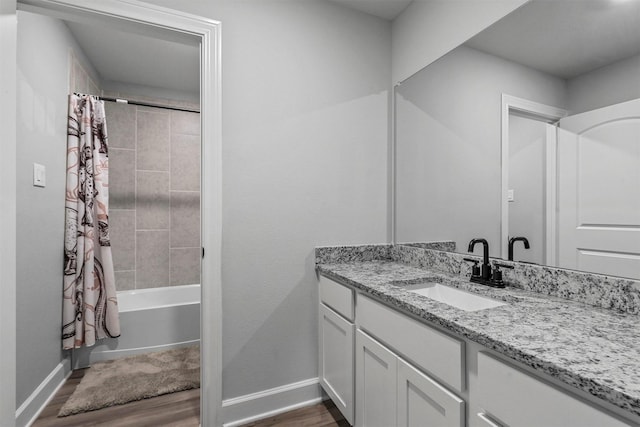 bathroom with shower / tub combo, vanity, and hardwood / wood-style floors