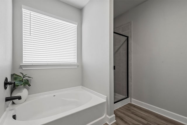 bathroom with separate shower and tub and hardwood / wood-style flooring