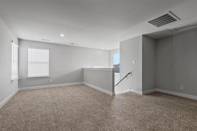 carpeted spare room with a wealth of natural light