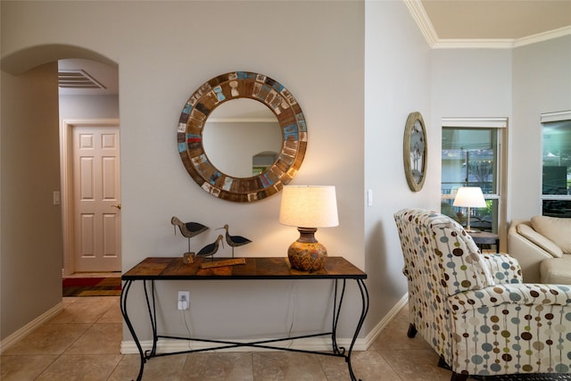 living area featuring ornamental molding and light tile patterned floors