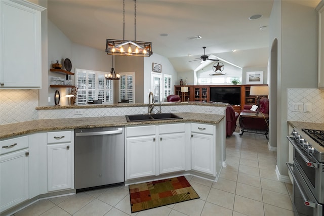 kitchen with vaulted ceiling, stainless steel appliances, a healthy amount of sunlight, and tasteful backsplash