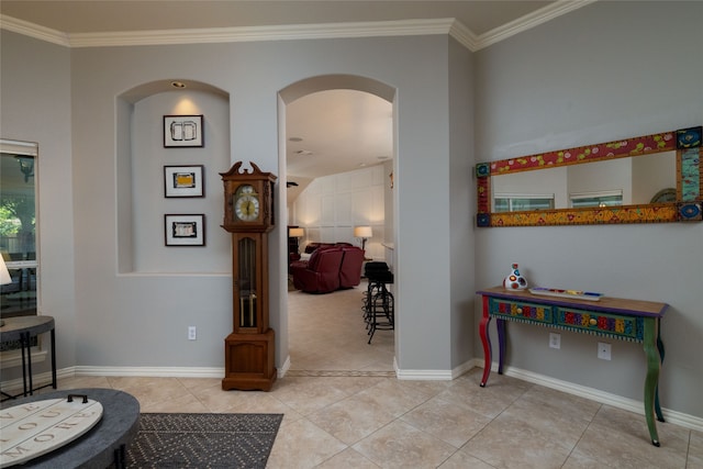 corridor featuring crown molding and light tile patterned floors