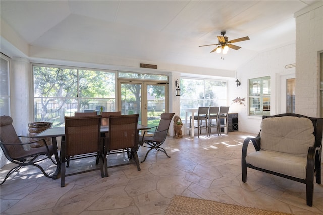 dining space with ceiling fan and vaulted ceiling