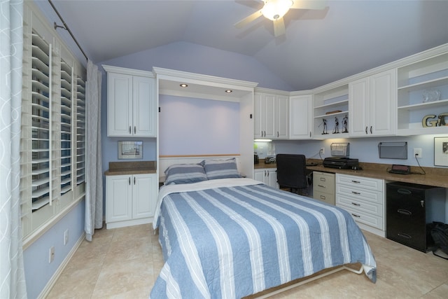 bedroom with built in desk, lofted ceiling, light tile patterned flooring, and ceiling fan