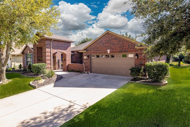 view of front of house featuring a garage and a front lawn